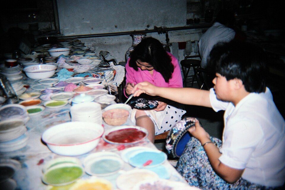 Artisans applying colour to cloisonné, archival factory photograph
