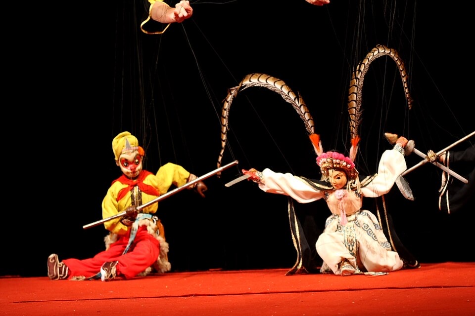 Two marionettes from the Quanzhou Puppet Troupe on a red stage in 2010, not at the museum