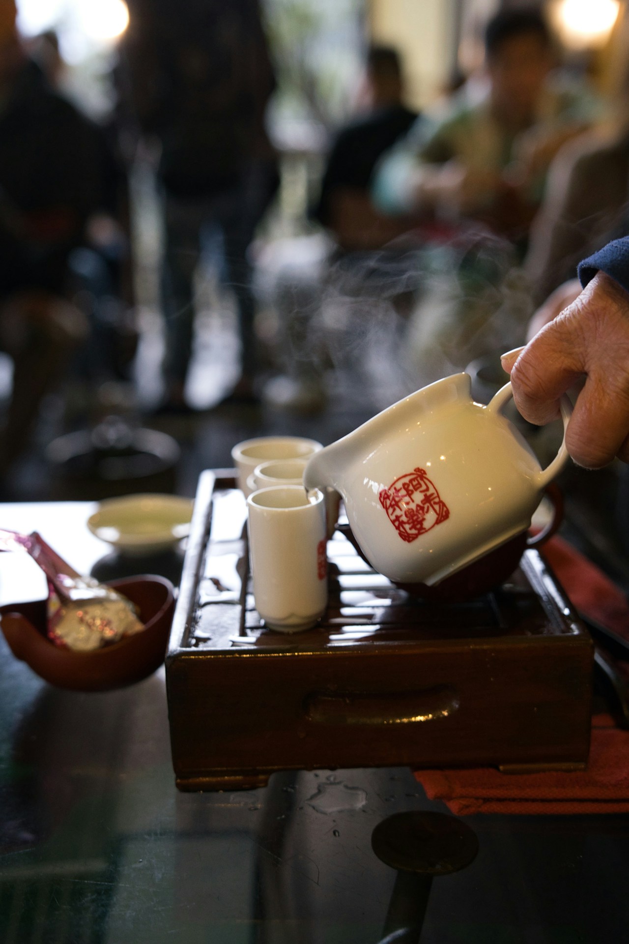 Tea being poured into a small cup