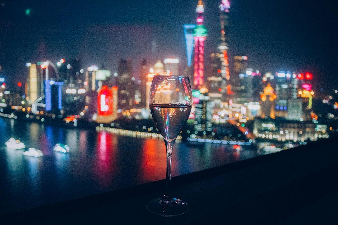 A wine glass in front of Shanghai at night